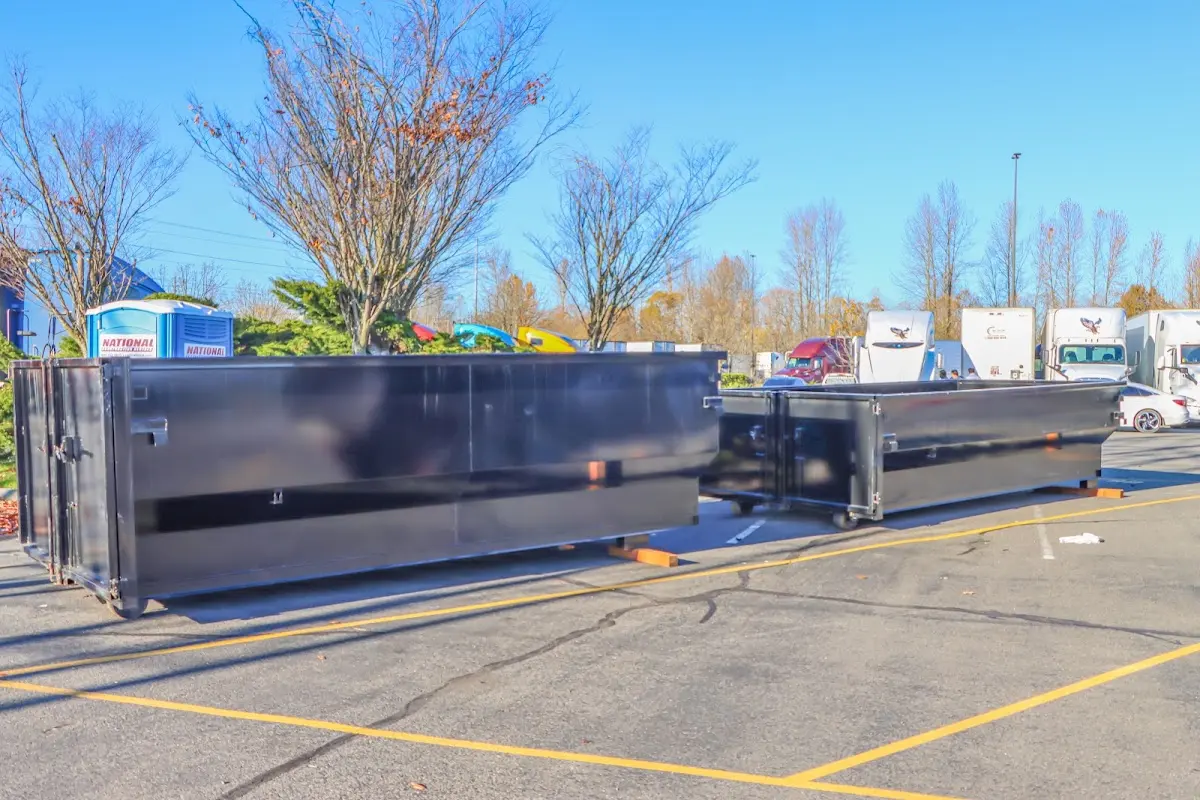 Professional dumpster rental service with roll-off container on residential driveway in Chesterton